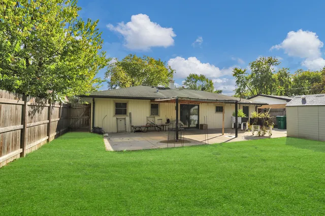 a front view of house with a garden and patio