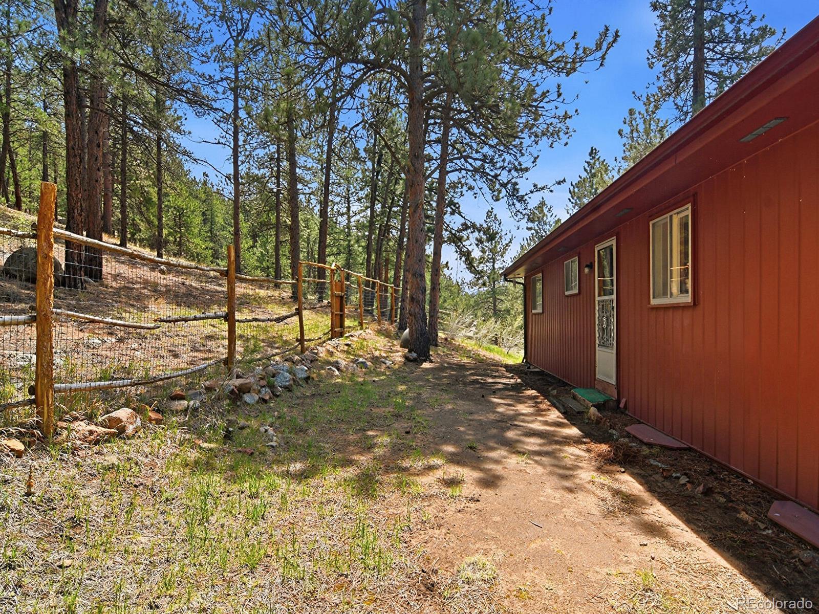 2830 Kerr Gulch Road Evergreen, CO 80439 - Photo 34 of 48 a backyard of a house with large trees