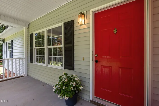a view of a porch with wooden floor and windows
