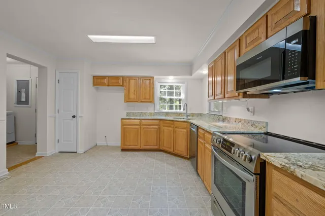 a kitchen with a sink cabinets and stainless steel appliances