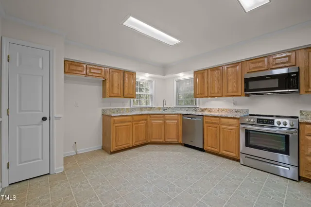 a kitchen with granite countertop a sink and a window
