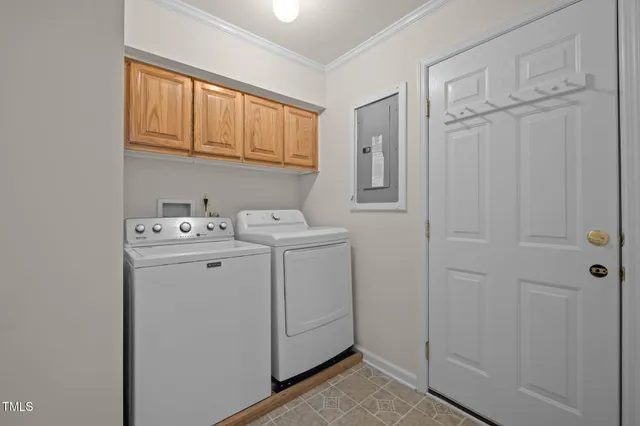 an empty room with chandelier fan and windows