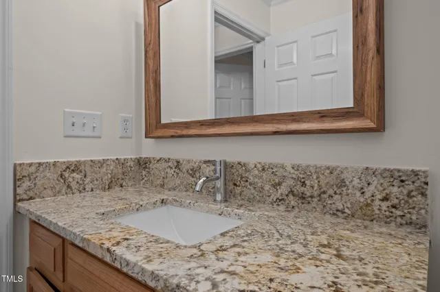 a front view of a house with a garden and trees