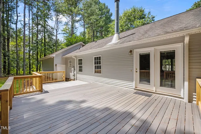 a view of backyard of house with trees