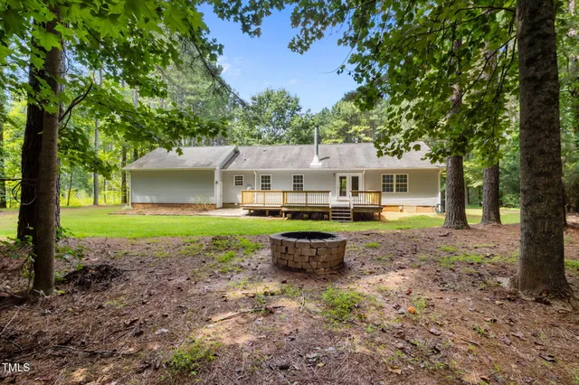 a view of a house with a yard and sitting area