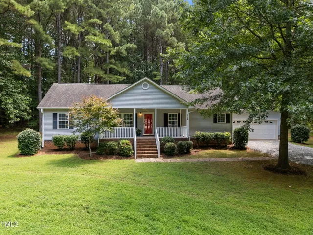 a front view of a house with a yard patio and fire pit