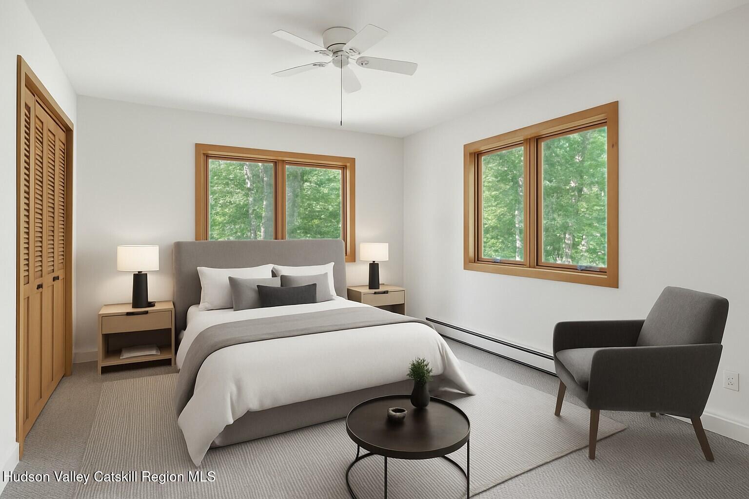 117 Spring Street Craryville, NY 12521 - Photo 16 of 31 a bedroom with a bed couches and chair with a window