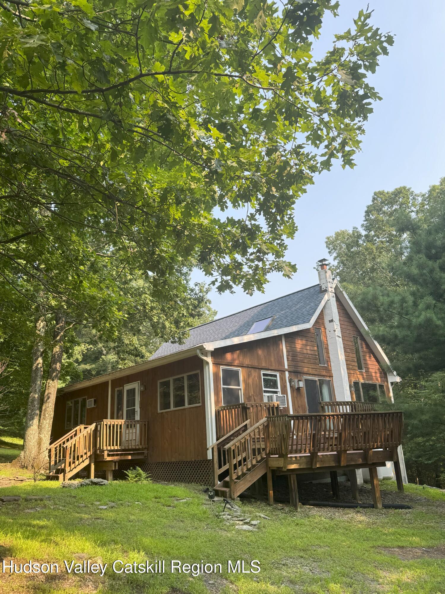117 Spring Street Craryville, NY 12521 - Photo 2 of 31 a front view of a house with a garden