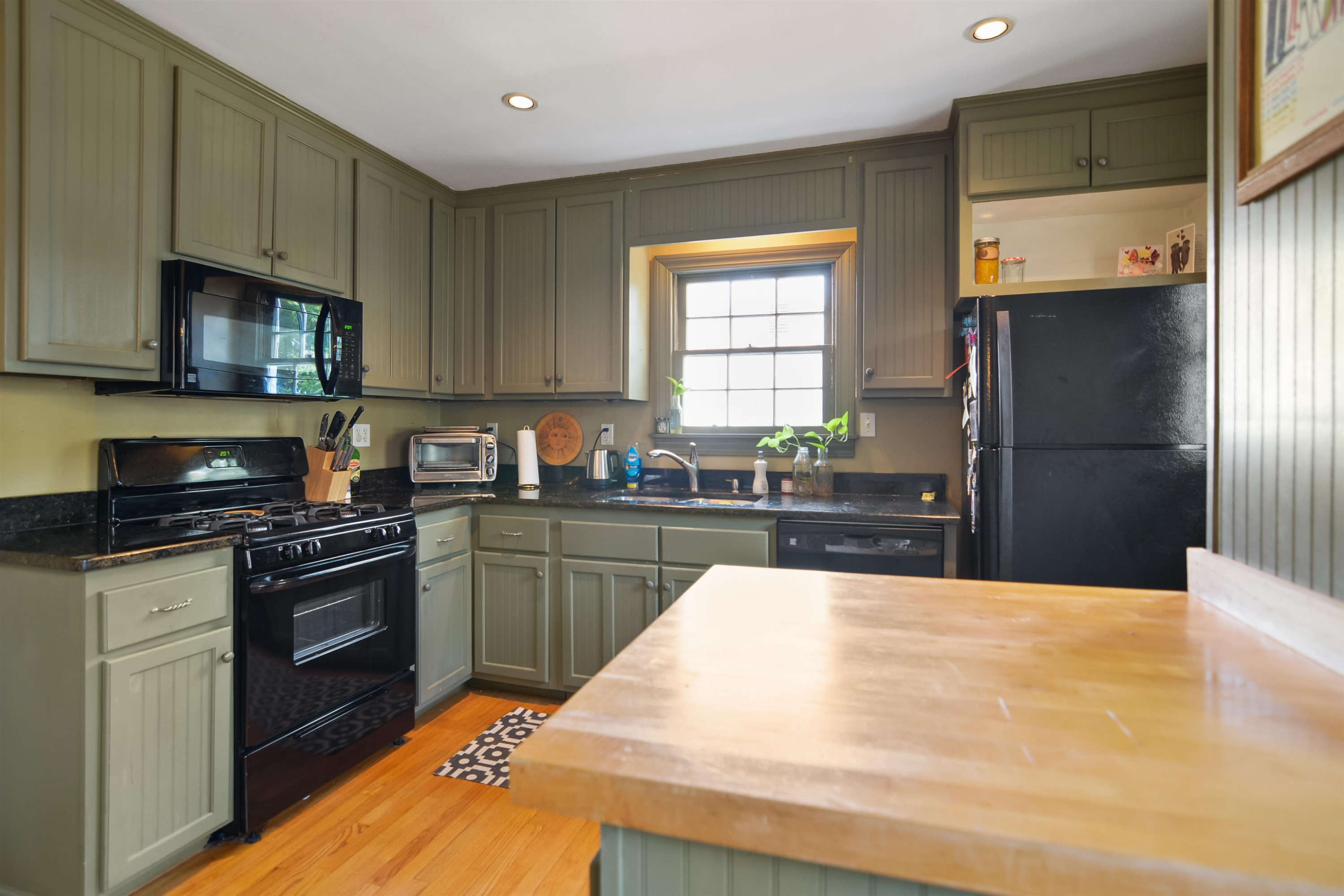 520 North Bloodworth Street Raleigh, NC 27604 - Photo 7 of 30 a kitchen with stainless steel appliances granite countertop a stove a sink and a refrigerator