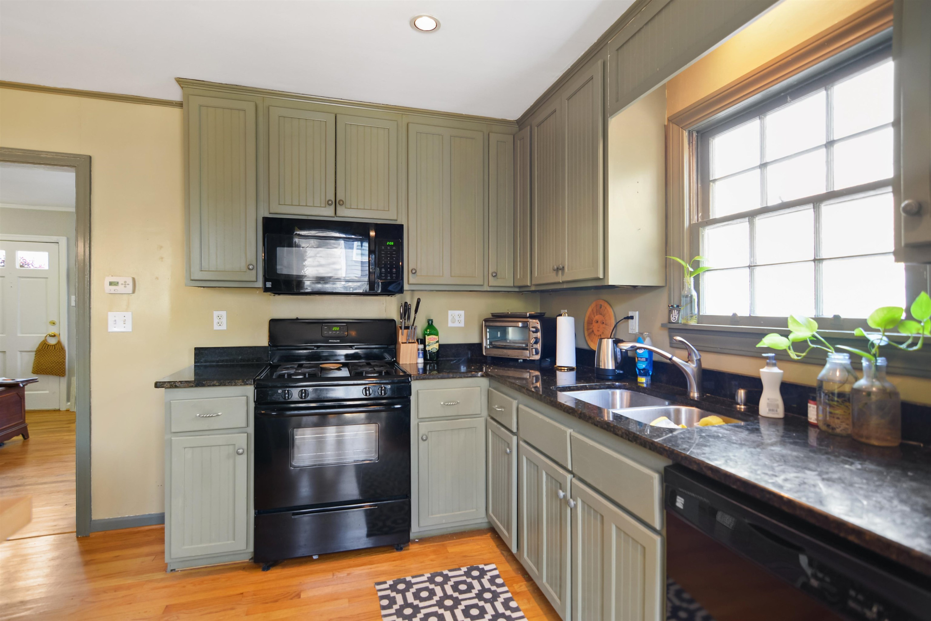 520 North Bloodworth Street Raleigh, NC 27604 - Photo 9 of 30 a kitchen with stainless steel appliances granite countertop a stove a sink and a microwave