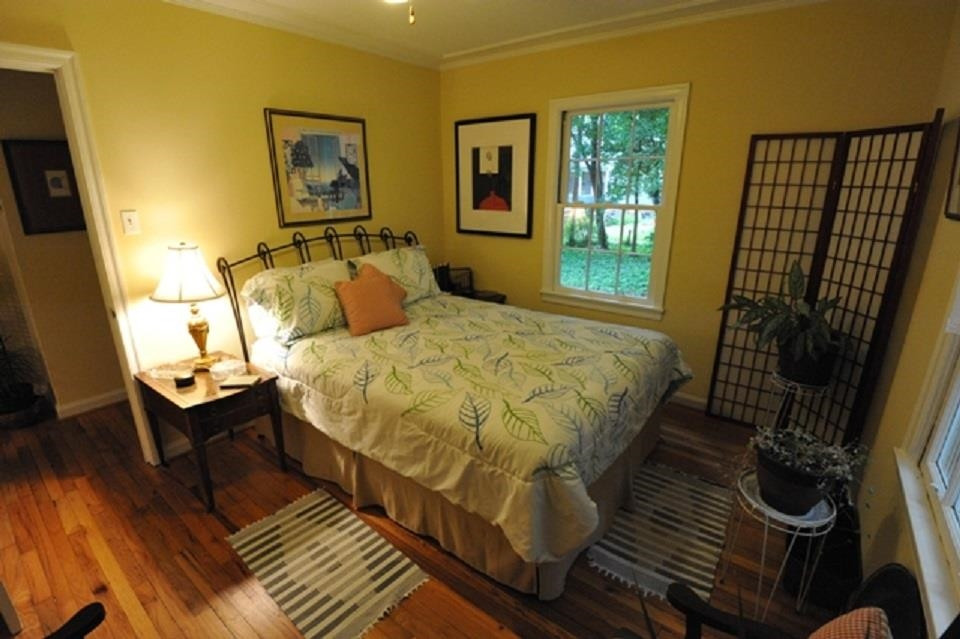 520 North Bloodworth Street Raleigh, NC 27604 - Photo 10 of 30 a bed sitting in a bedroom next to a window