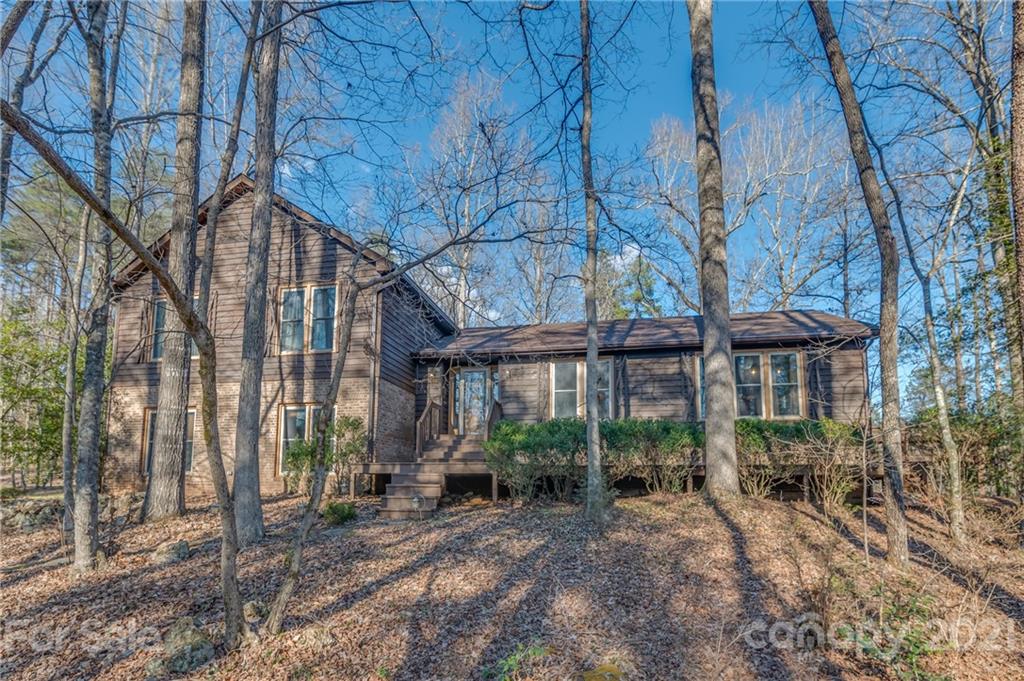301 Willow Pond Road Rutherfordton, NC 28139 - Photo 1 of 42 a view of a brick house with large windows and a tree
