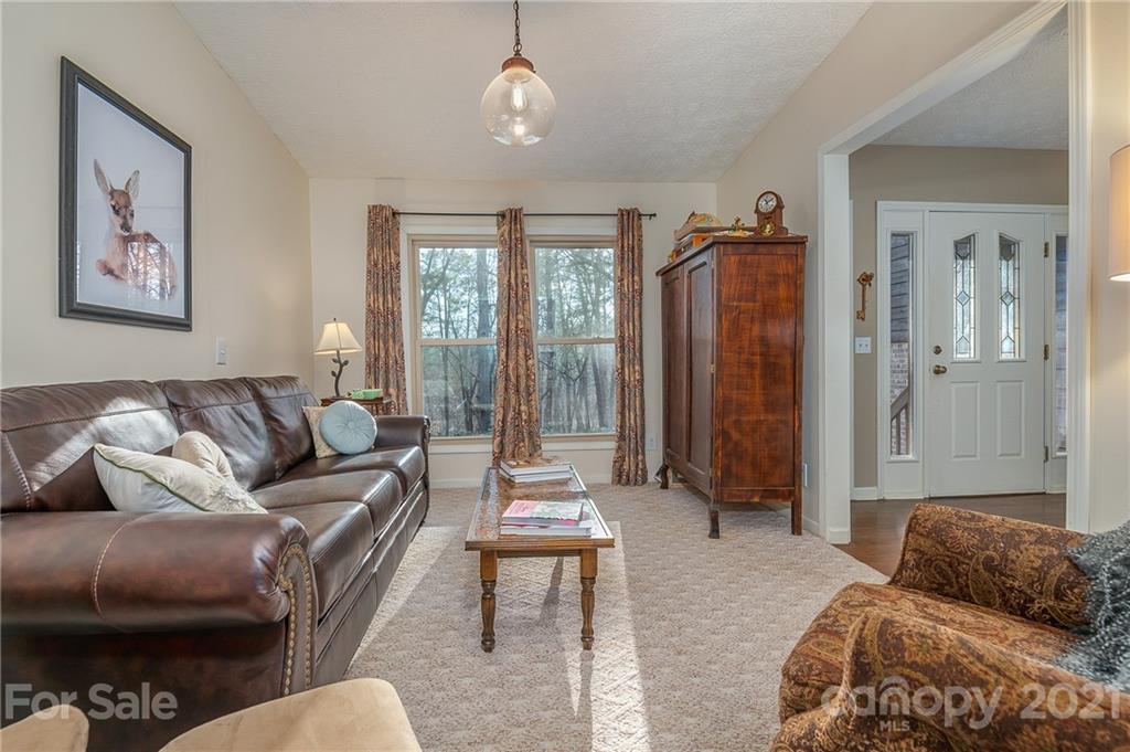 301 Willow Pond Road Rutherfordton, NC 28139 - Photo 15 of 42 a living room with furniture and a chandelier