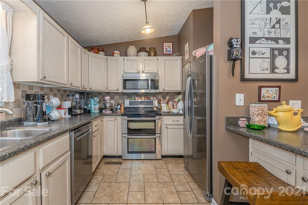 301 Willow Pond Road Rutherfordton, NC 28139 - Photo 20 of 42 a kitchen with stainless steel appliances granite countertop a refrigerator sink and cabinets