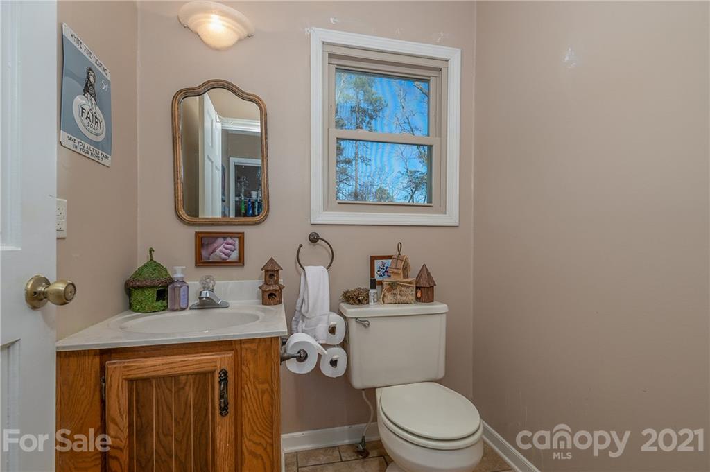 301 Willow Pond Road Rutherfordton, NC 28139 - Photo 23 of 42 a bathroom with a toilet a sink and mirror