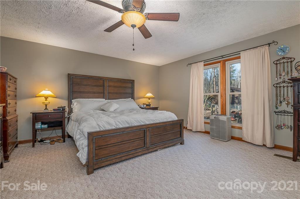 301 Willow Pond Road Rutherfordton, NC 28139 - Photo 24 of 42 a bedroom with a bed and a chandelier