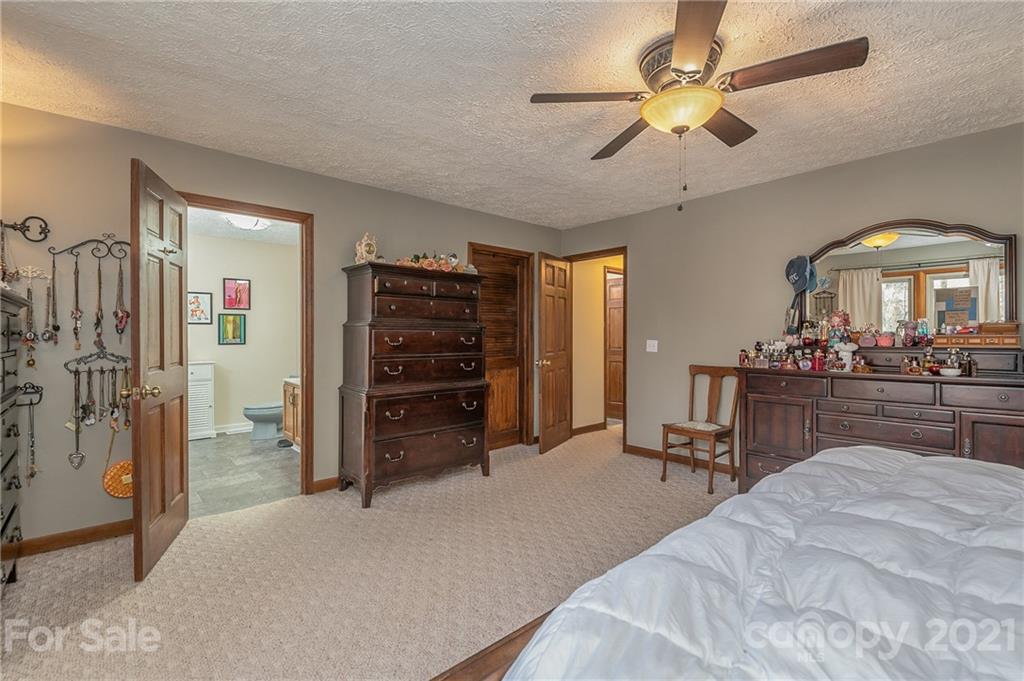 301 Willow Pond Road Rutherfordton, NC 28139 - Photo 25 of 42 a bedroom with a bed and a chandelier