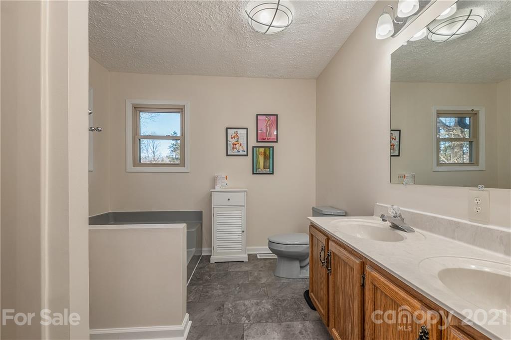 301 Willow Pond Road Rutherfordton, NC 28139 - Photo 26 of 42 a bathroom with a sink a toilet and a tub