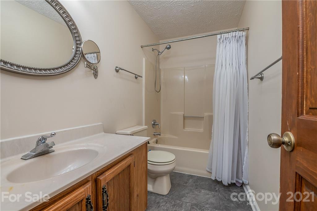 301 Willow Pond Road Rutherfordton, NC 28139 - Photo 28 of 42 a bathroom with a granite countertop sink toilet and shower