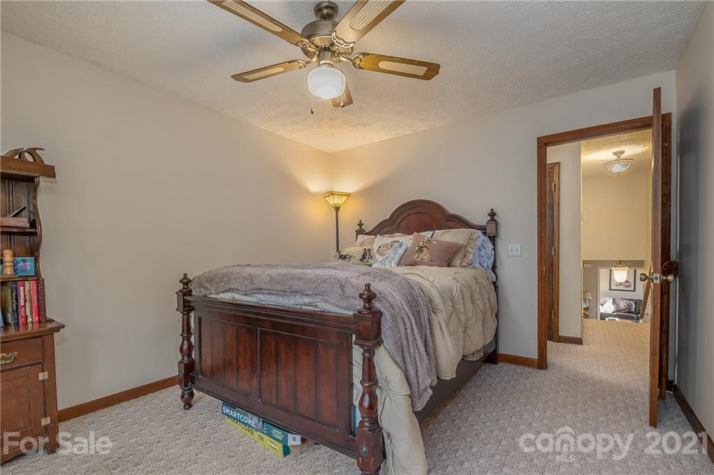 301 Willow Pond Road Rutherfordton, NC 28139 - Photo 29 of 42 a bedroom with a bed and a chandelier