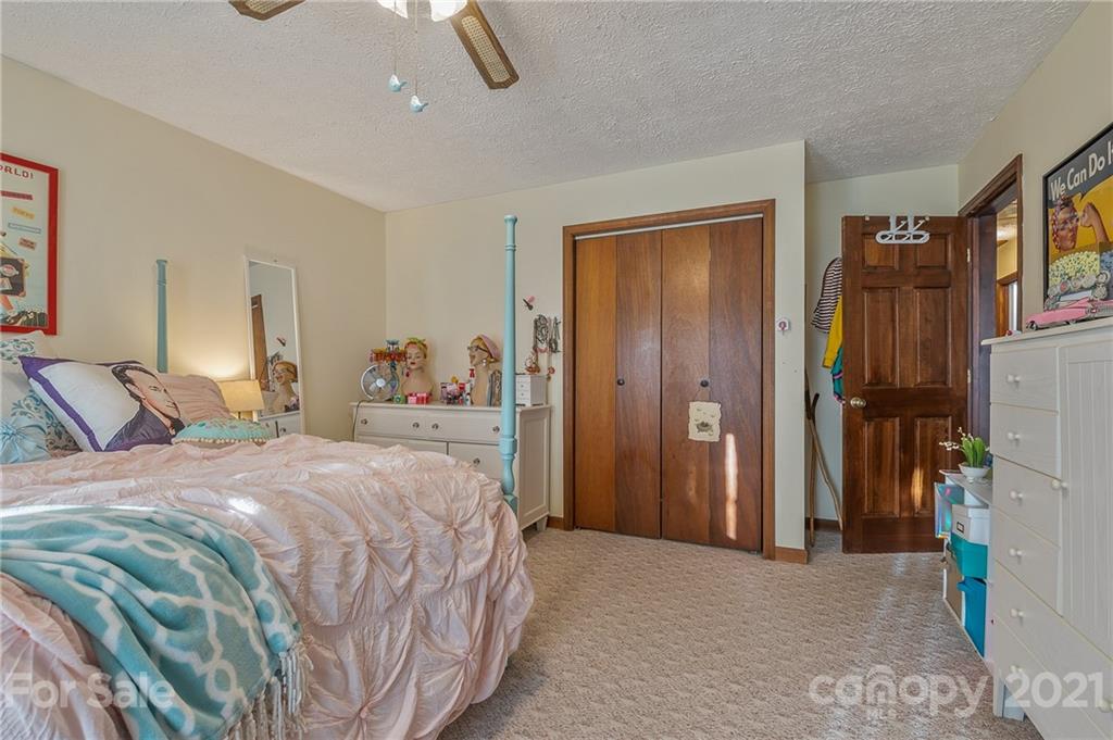 301 Willow Pond Road Rutherfordton, NC 28139 - Photo 32 of 42 a bedroom with a bed closet and a mirror