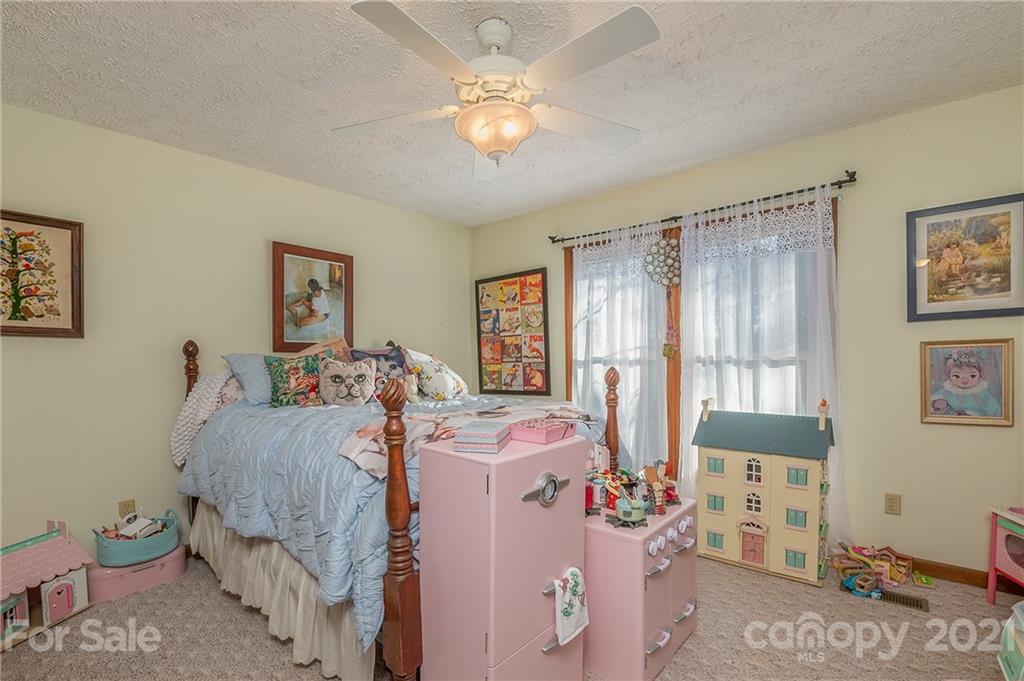 301 Willow Pond Road Rutherfordton, NC 28139 - Photo 33 of 42 a bedroom with a bed and a chandelier