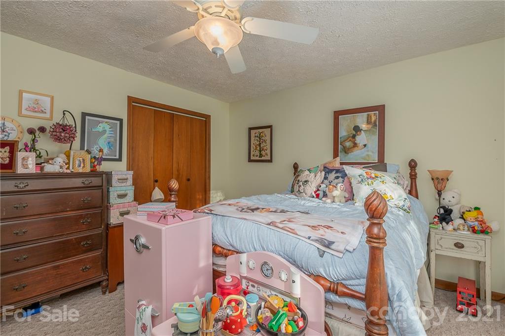 301 Willow Pond Road Rutherfordton, NC 28139 - Photo 34 of 42 a bed room with a bed and a baby bed