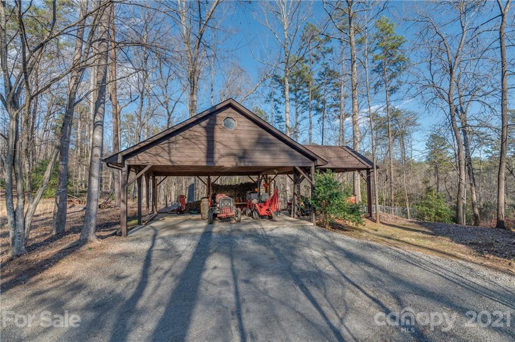 301 Willow Pond Road Rutherfordton, NC 28139 - Photo 37 of 42 a view of a wooden house with a large tree and wooden fence