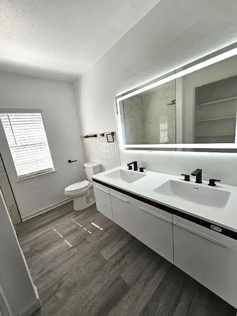 a bathroom with a sink and a large mirror