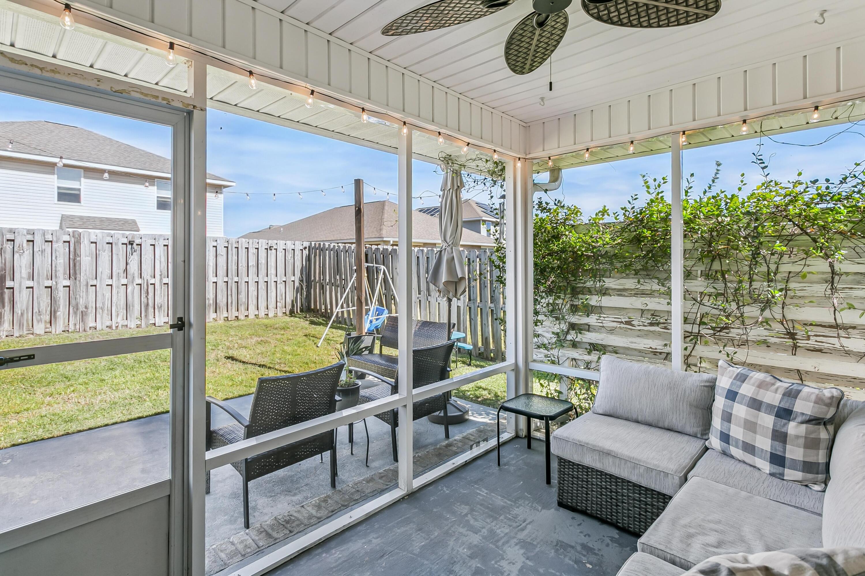 936 Merganser Way Crestview, FL 32539 - Photo 26 of 39 a living room with furniture and a floor to ceiling window