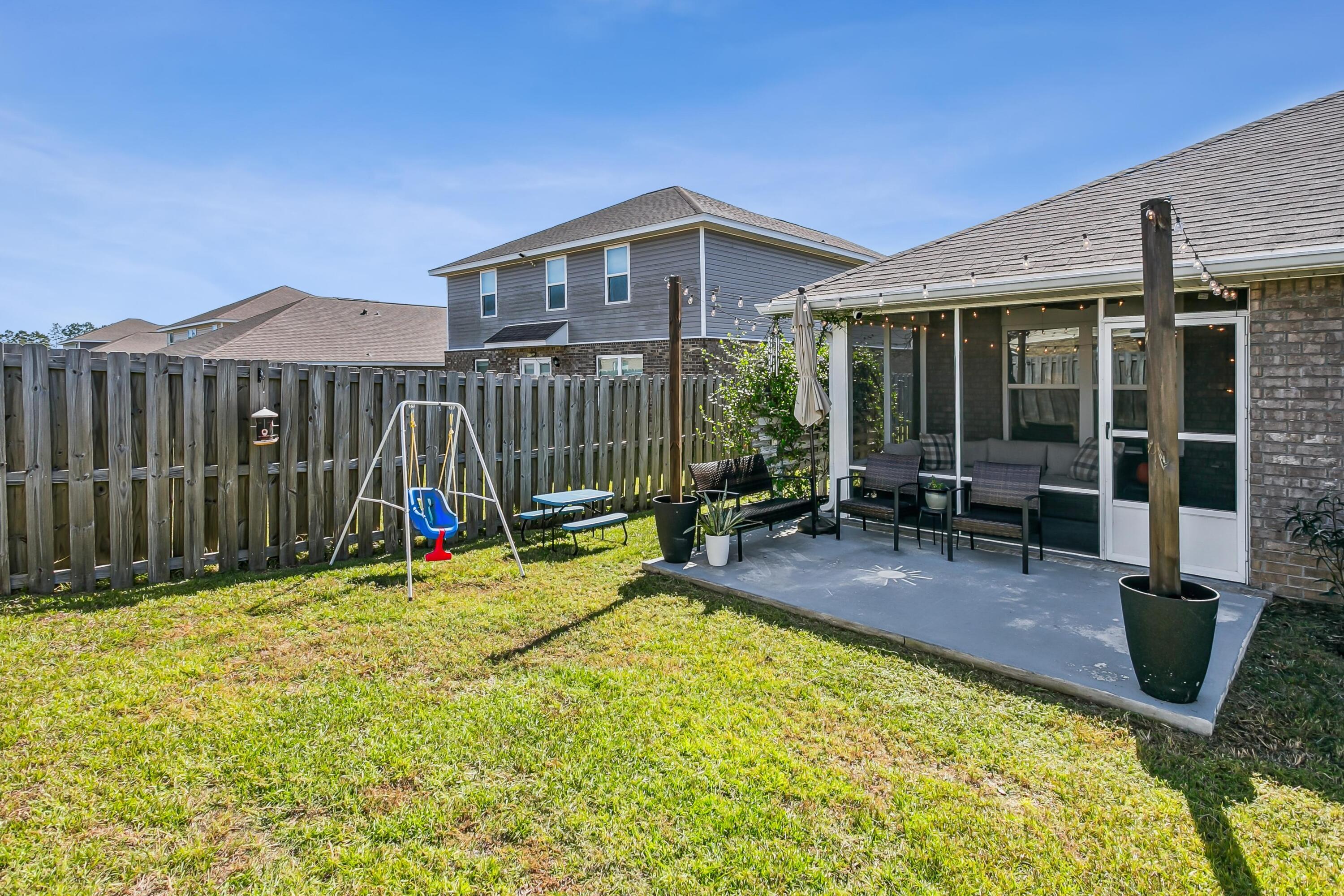936 Merganser Way Crestview, FL 32539 - Photo 29 of 39 a view of a house with backyard porch and sitting area