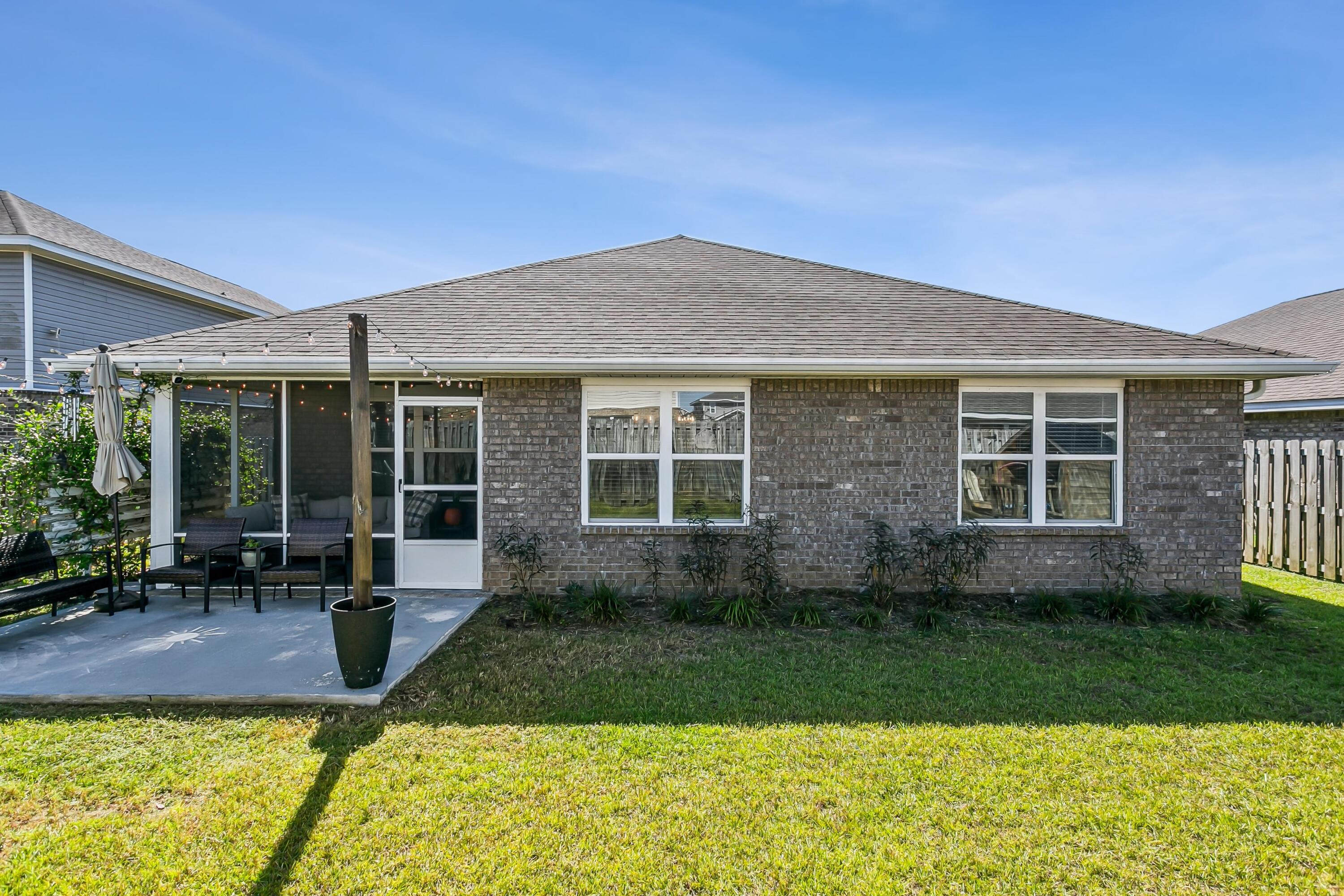 936 Merganser Way Crestview, FL 32539 - Photo 30 of 39 a front view of a house with a yard and outdoor seating