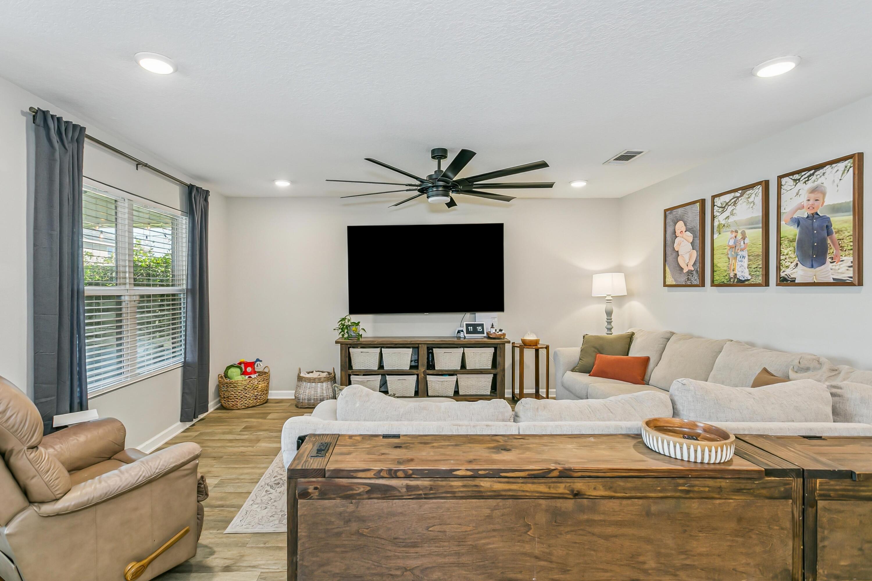 936 Merganser Way Crestview, FL 32539 - Photo 6 of 39 a living room with furniture and a flat screen tv