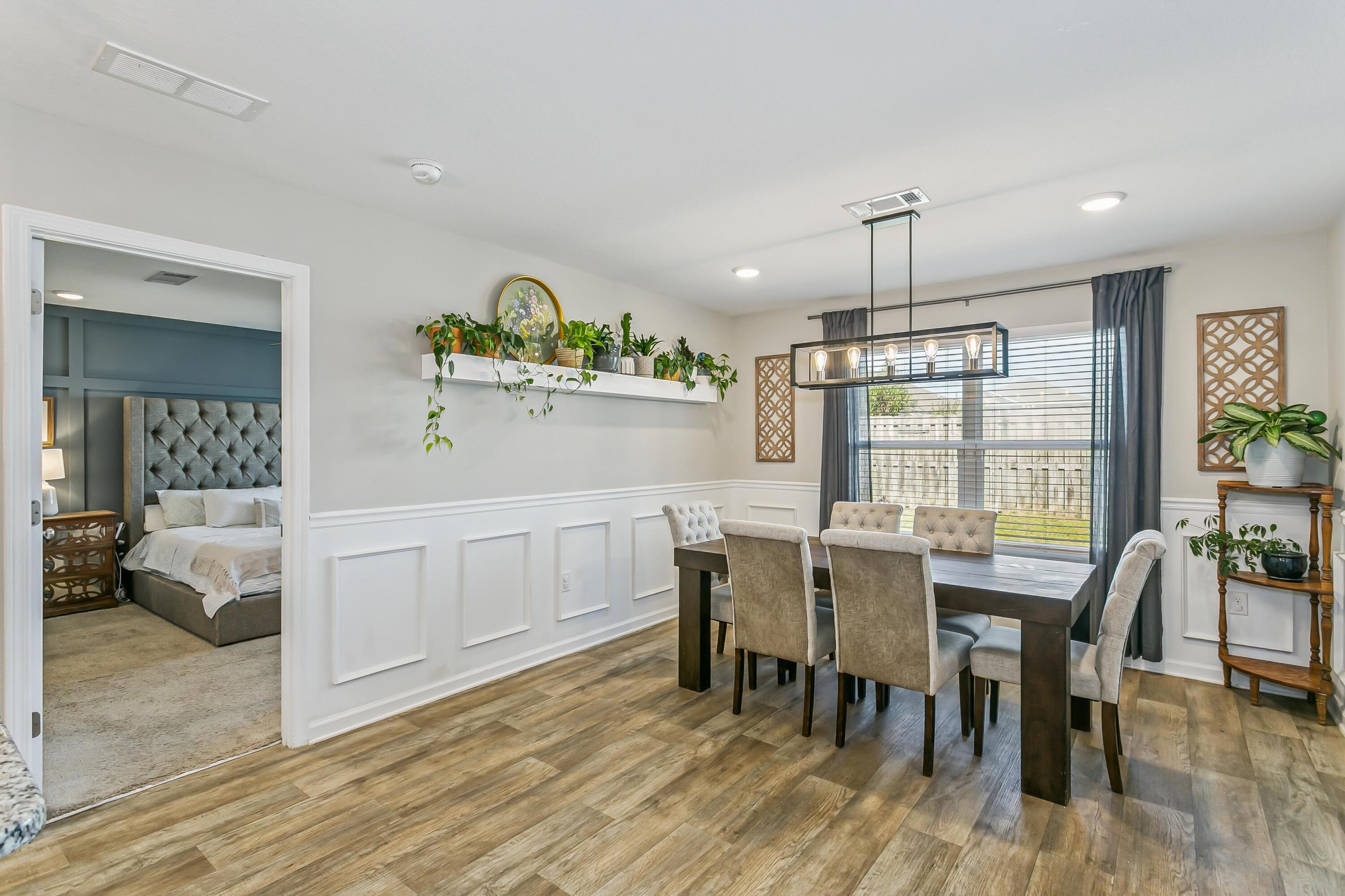 936 Merganser Way Crestview, FL 32539 - Photo 8 of 39 a view of a dining room with furniture window and wooden floor