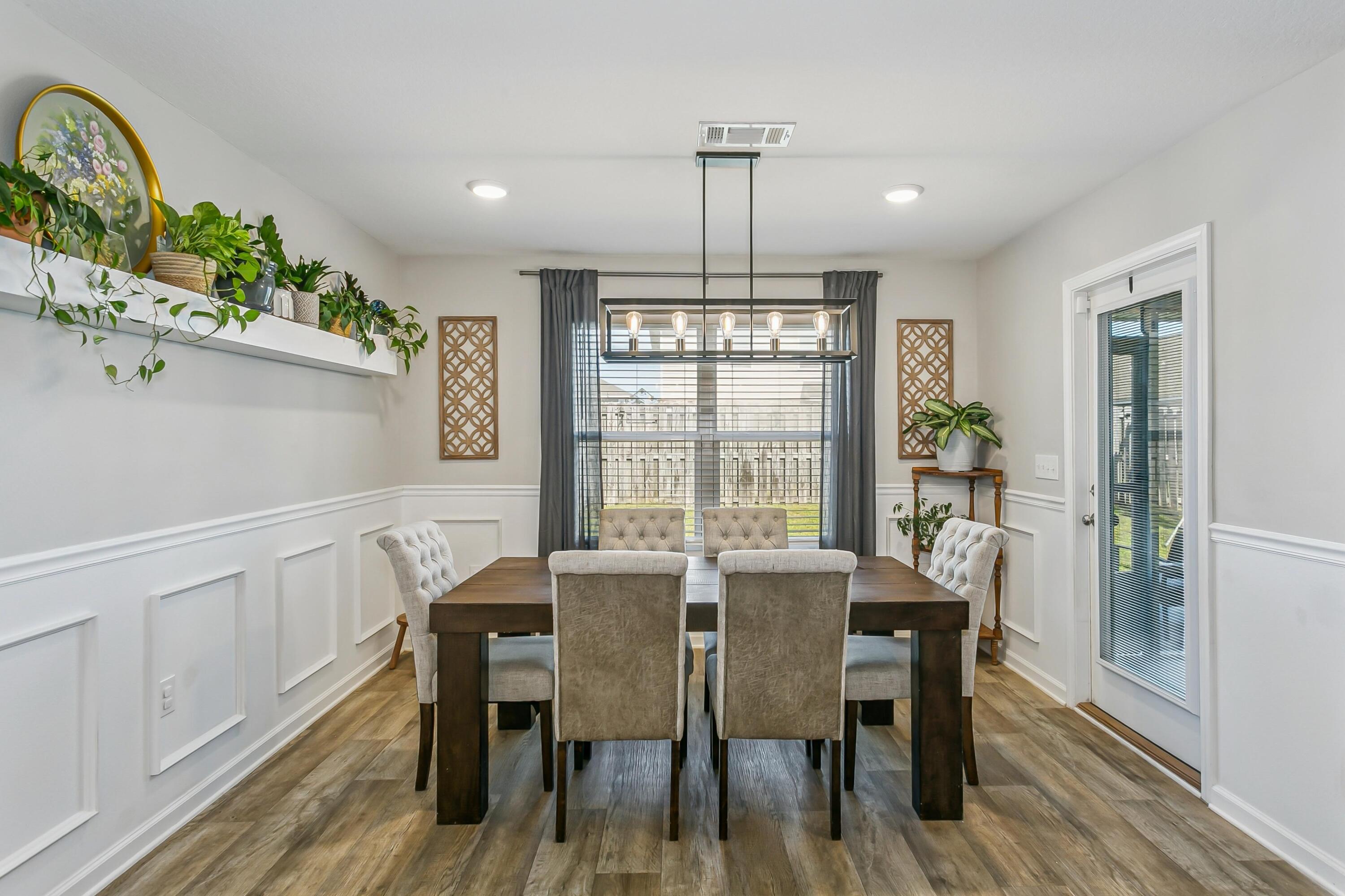 936 Merganser Way Crestview, FL 32539 - Photo 10 of 39 a view of a dining room with furniture window and wooden floor