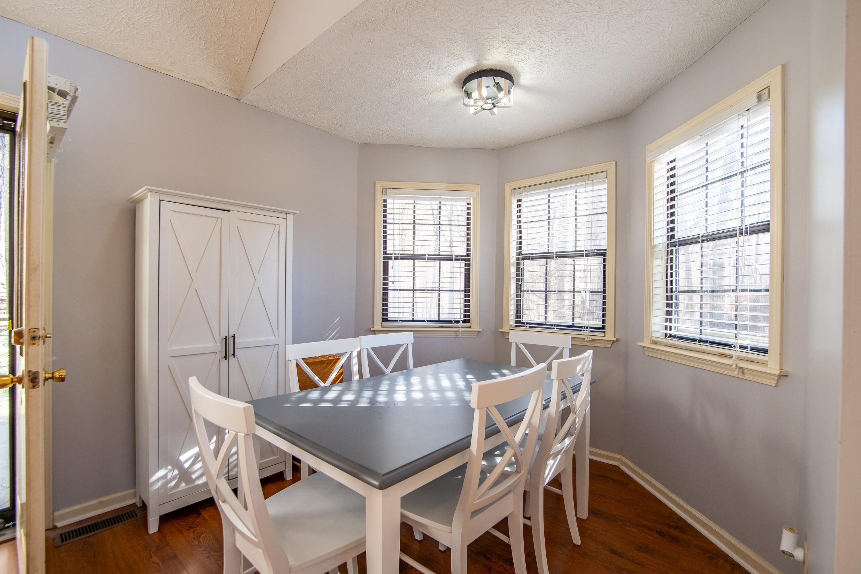 315 Bryson Harbor Road Counce, TN 38326 - Photo 16 of 37 a view of a dining room with furniture a chandelier and wooden floor