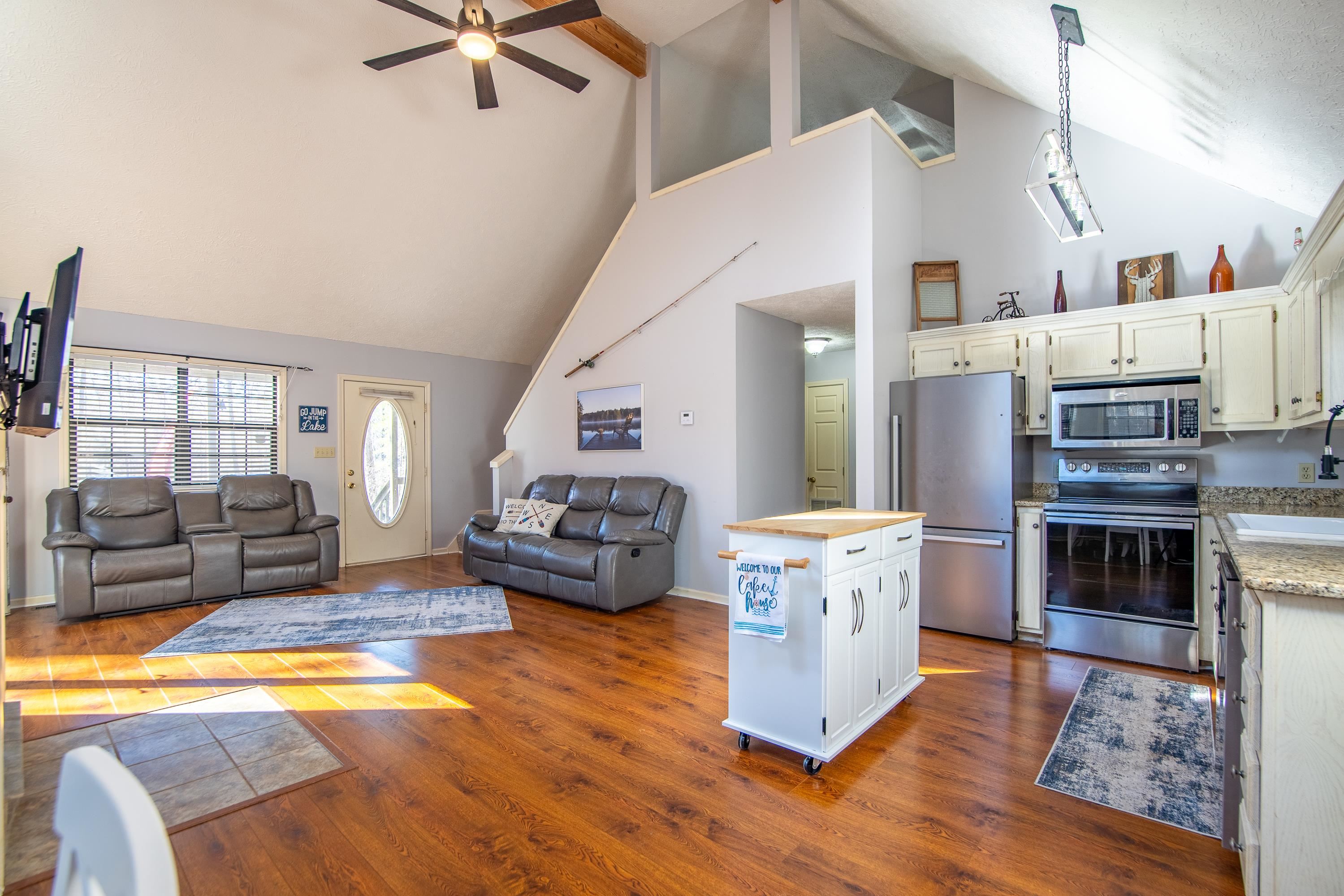 315 Bryson Harbor Road Counce, TN 38326 - Photo 17 of 37 a kitchen with stainless steel appliances granite countertop a stove a sink and a refrigerator