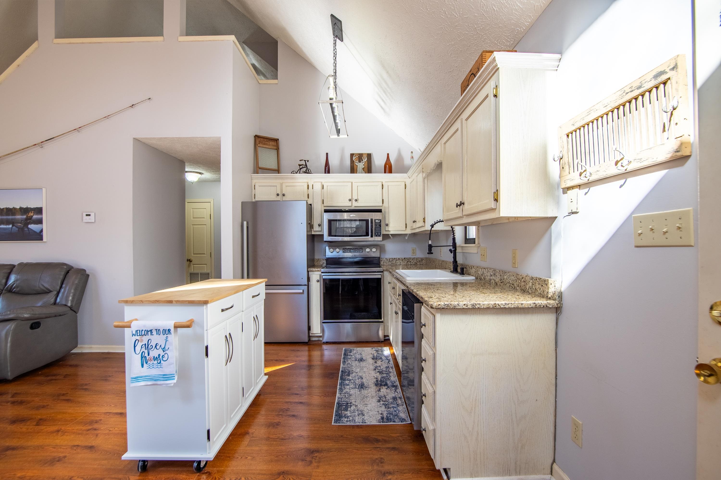 315 Bryson Harbor Road Counce, TN 38326 - Photo 18 of 37 a kitchen with stainless steel appliances granite countertop a stove and a refrigerator