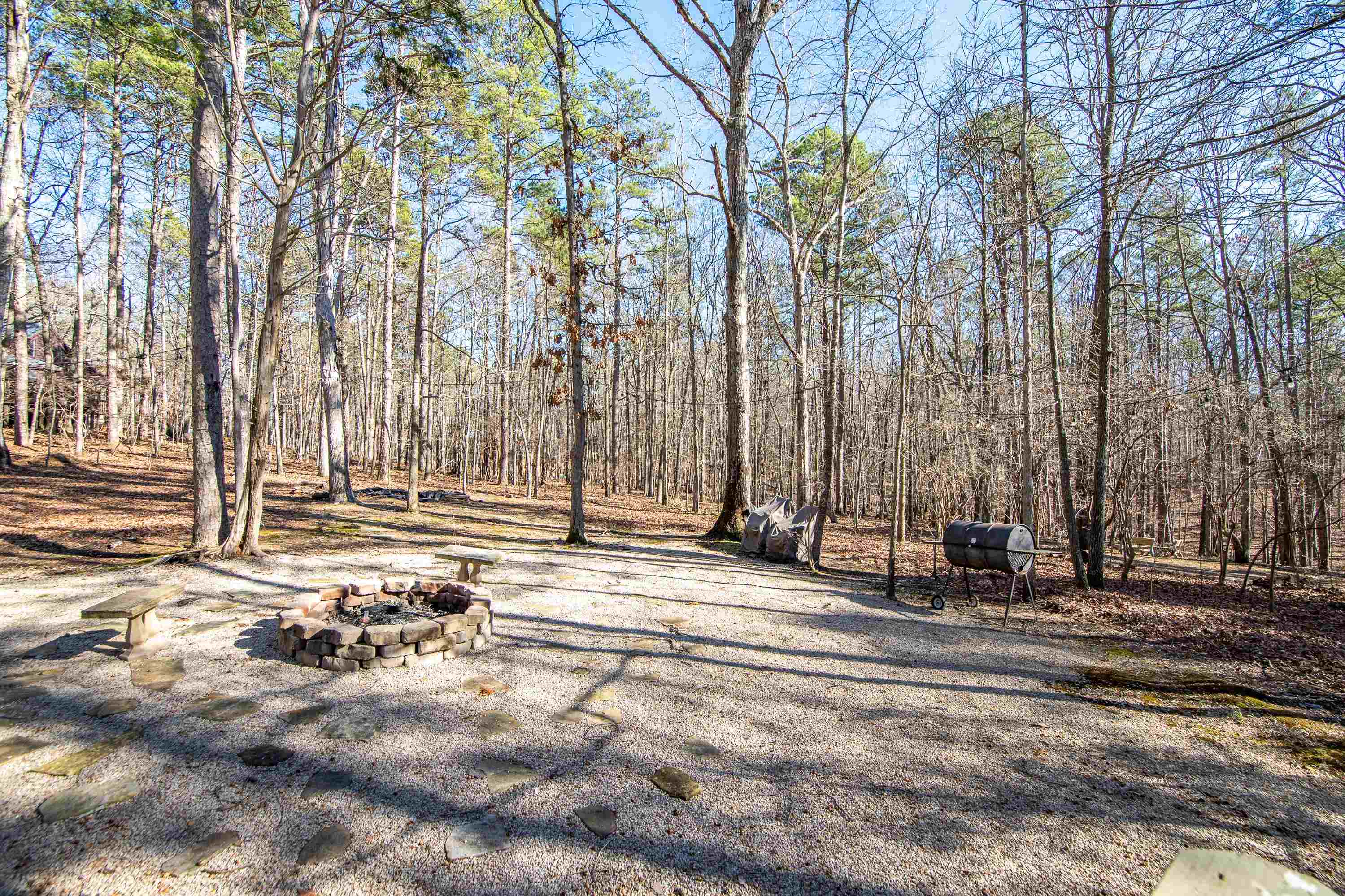 315 Bryson Harbor Road Counce, TN 38326 - Photo 29 of 37 a backyard of a house with large trees and wooden fence