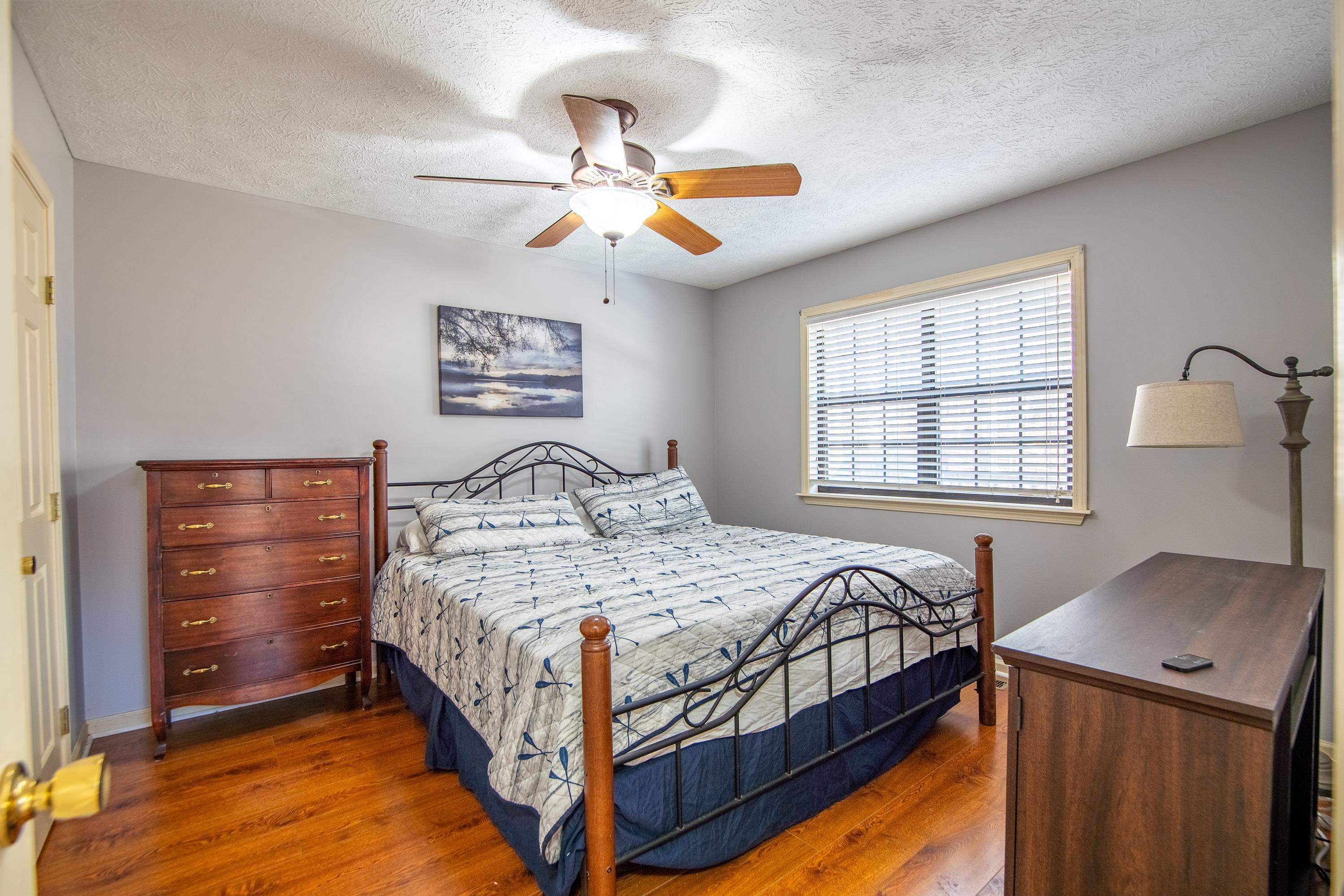 315 Bryson Harbor Road Counce, TN 38326 - Photo 6 of 37 a bedroom with a bed and a chandelier