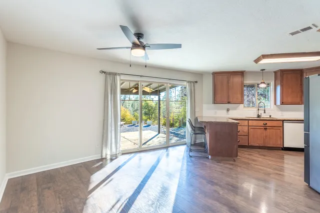 a bathroom with a granite countertop toilet a sink and a mirror