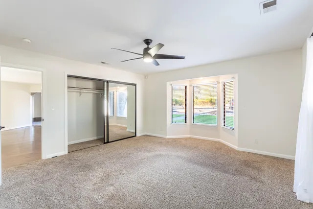 a view of a house with a yard and large tree