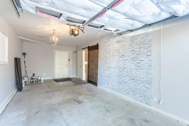 a view of a yard with plants and trees