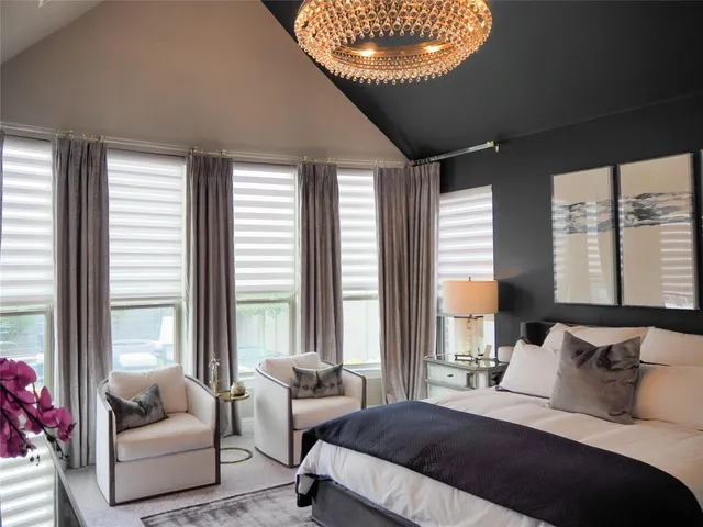 a bedroom with a bed and a large window