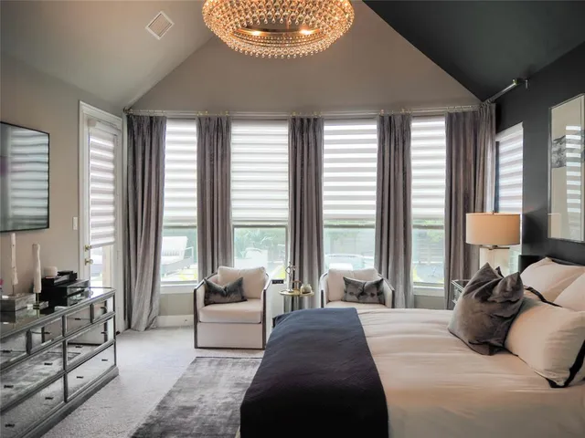 a bedroom with a large bed and a large window