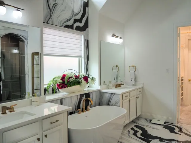 a bathroom with a sink double vanity and a mirror