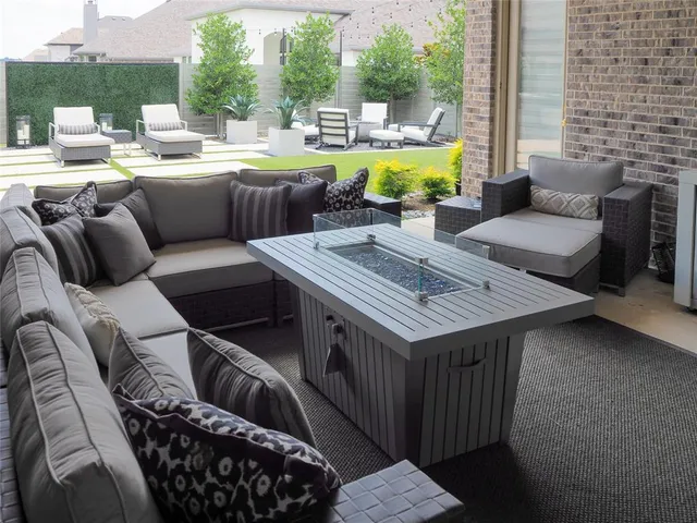 a view of a patio with couches chairs and a fire pit