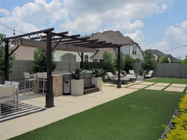 a view of a patio with table and chairs potted plants