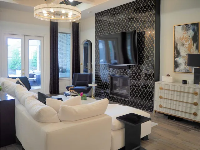 a living room with furniture and a chandelier