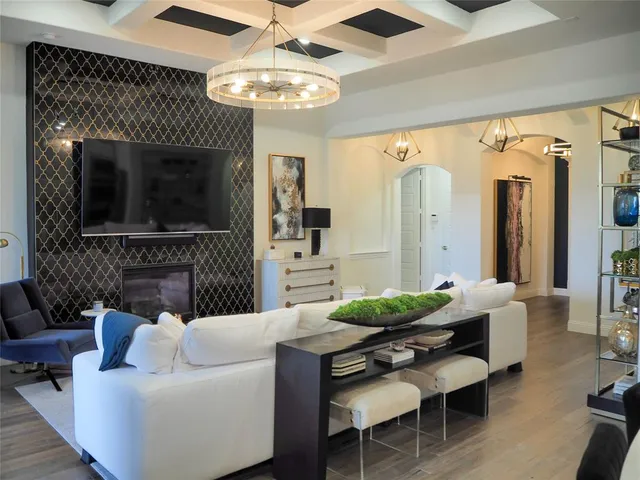 a living room with furniture a fireplace and a flat screen tv